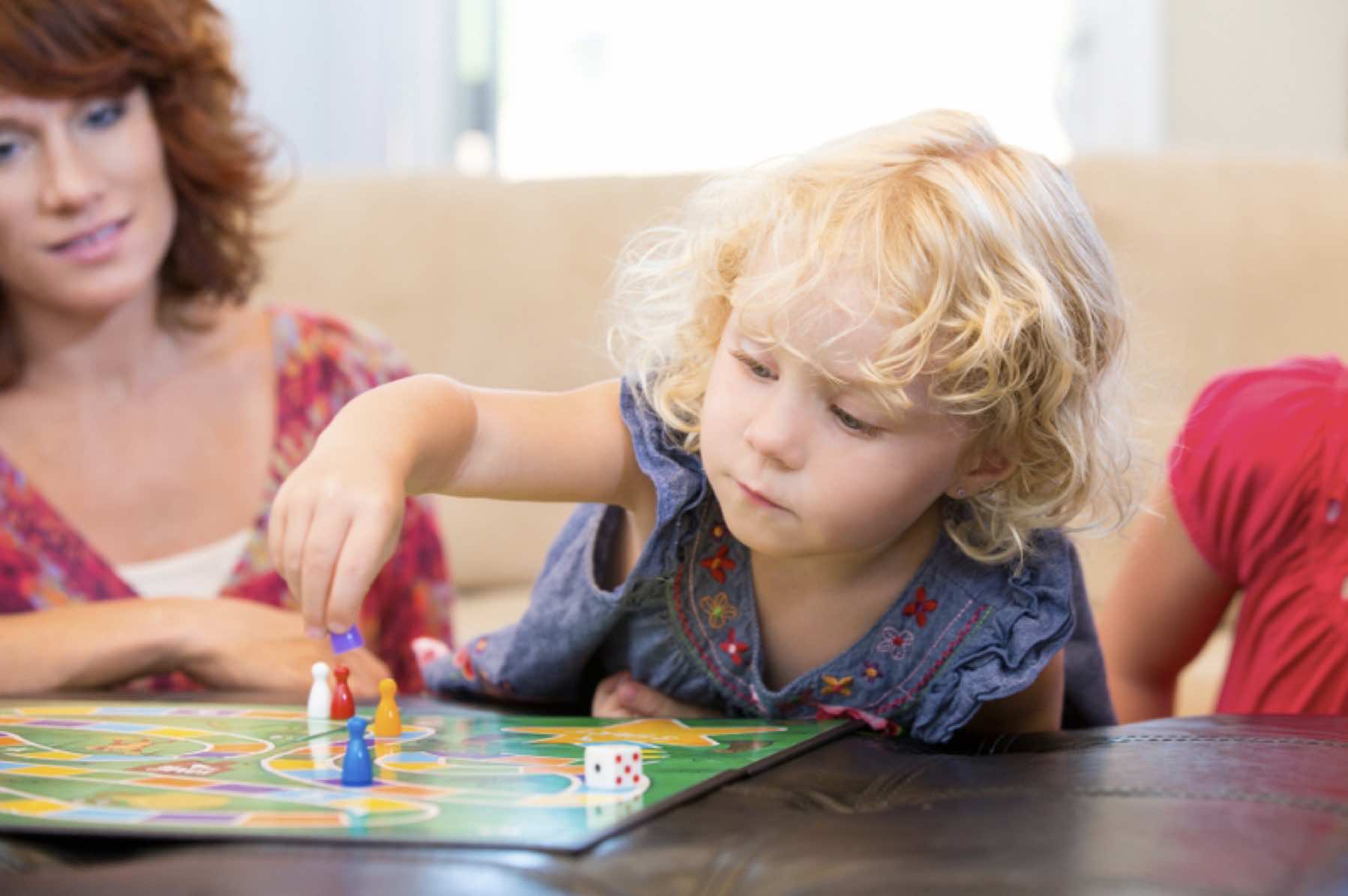 enfant joue  devant adulte