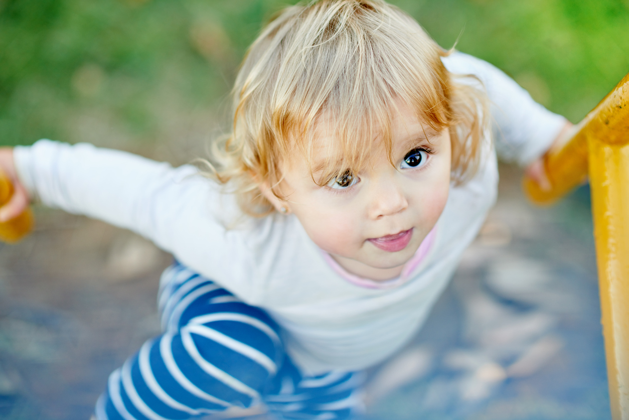 petit enfant qui grimpe sur une structure 