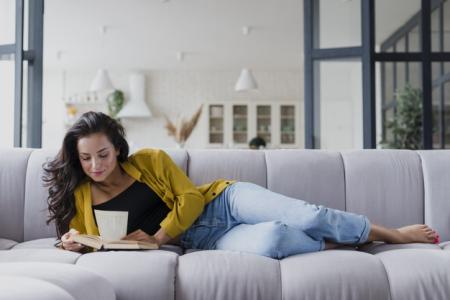 femme lit sur un canapé 